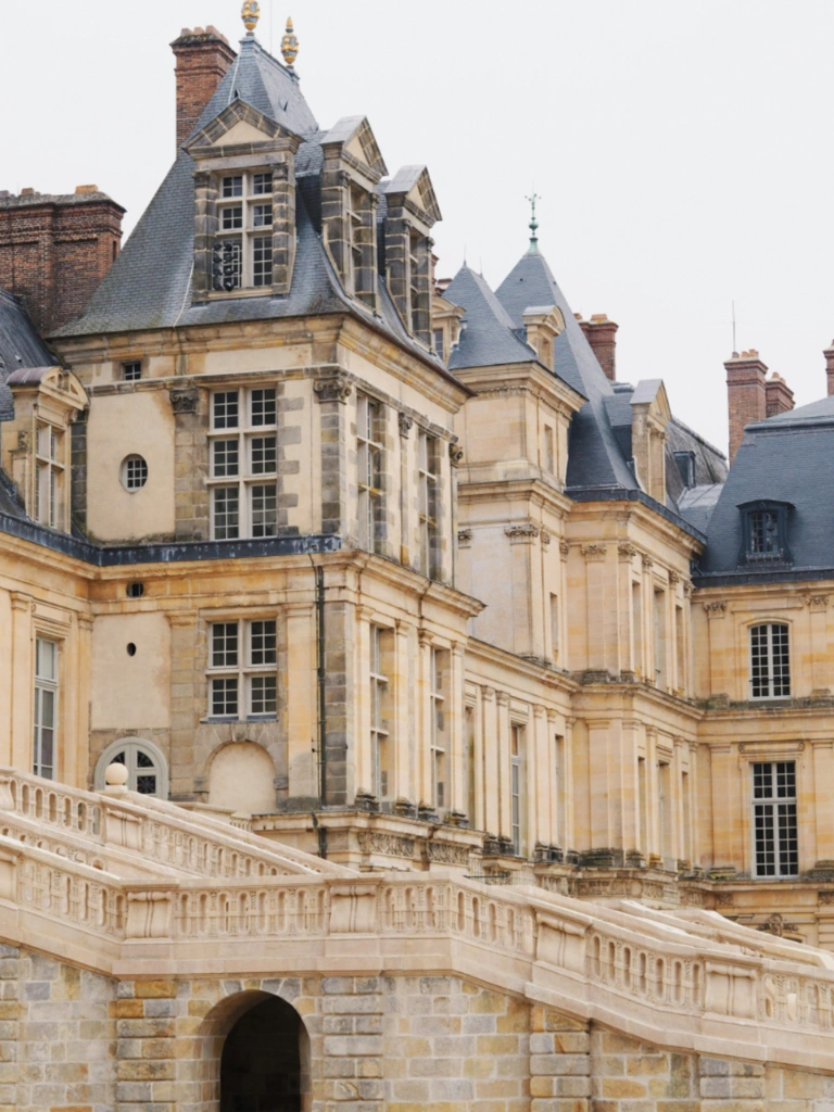 Château de Fontainebleau featuring its stone horseshoe staircase and French Renaissance architecture.